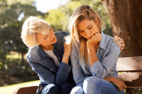 Mom comforting adult daughter