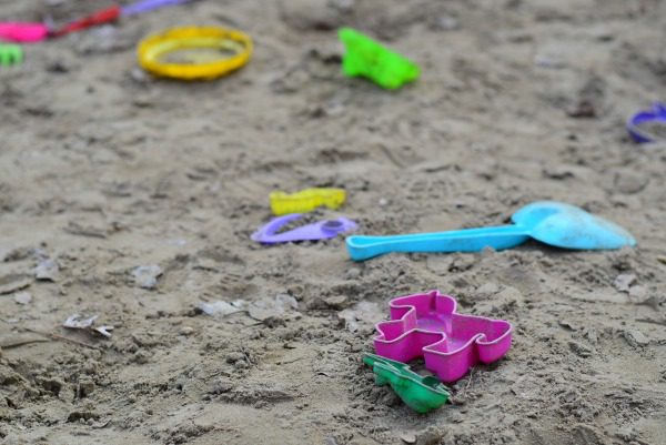 Abandoned toys in sandbox