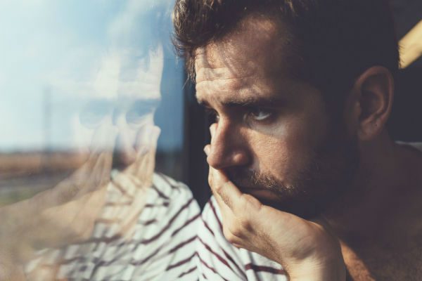 Man by window in deep thought